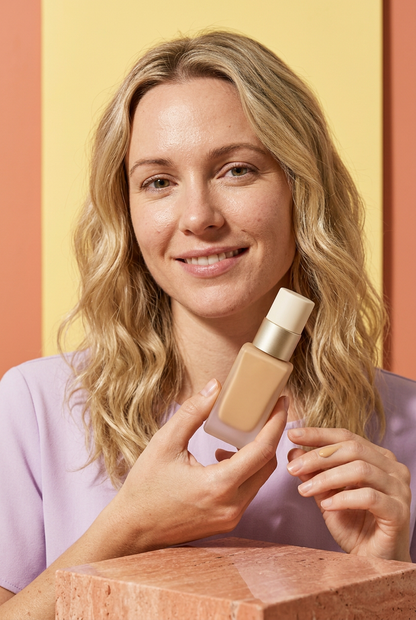 AI-generated blonde adult model holding unbranded foundation bottle