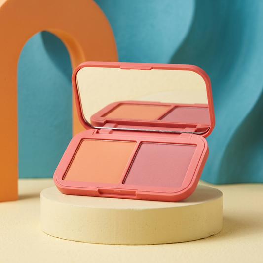 Main image 1: apricot and rose duo blush in a coral compact on a yellow pedestal