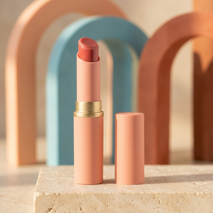 Tinted lip balm on cream stone with peach and turquoise arches